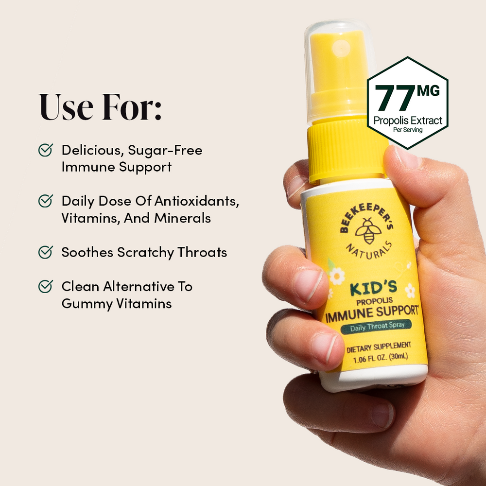 Kids Propolis Throat Spray held in hand, with info on immune support and antioxidants. "77MG Propolis Extract Per Serving".