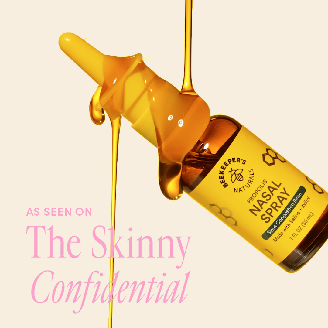 Beekeeper's Naturals Propolis Nasal Spray with liquid flowing out on a beige background.