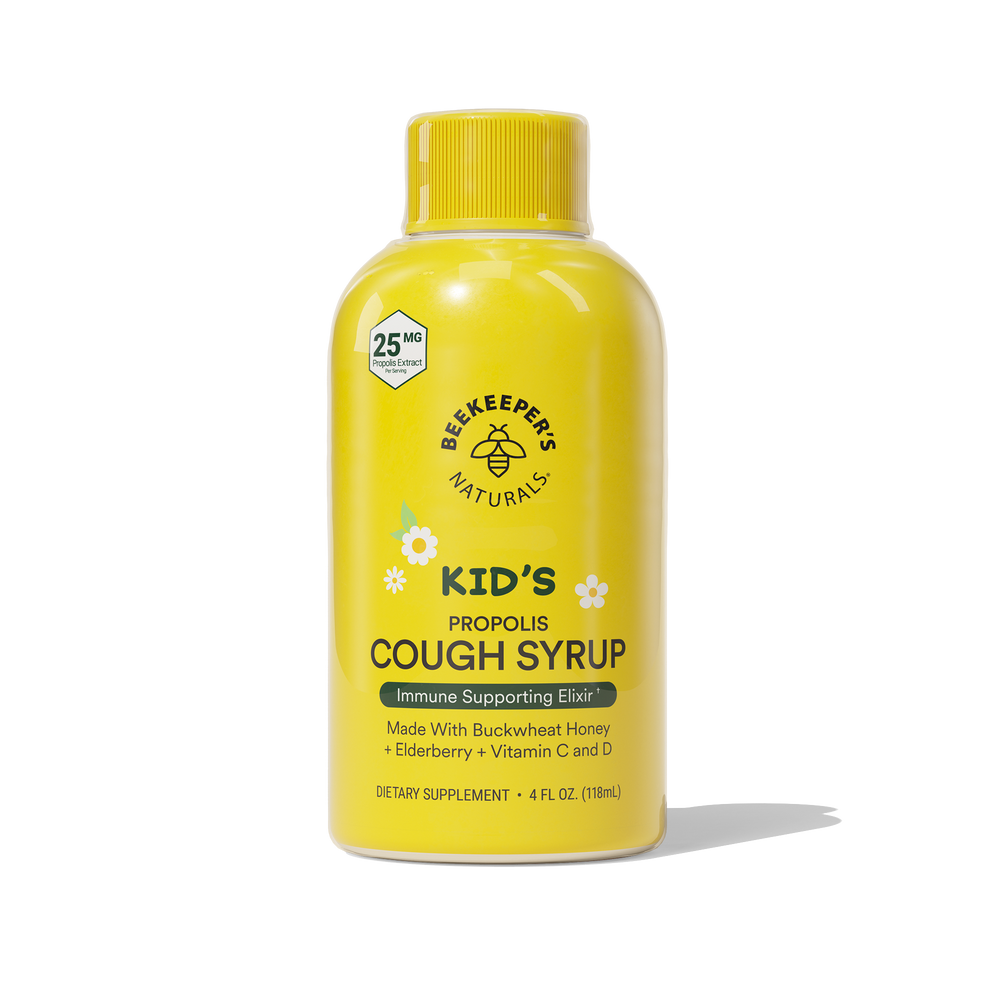 A bottle of Kids Daytime Honey Cough Syrup with natural ingredients listed on the label.