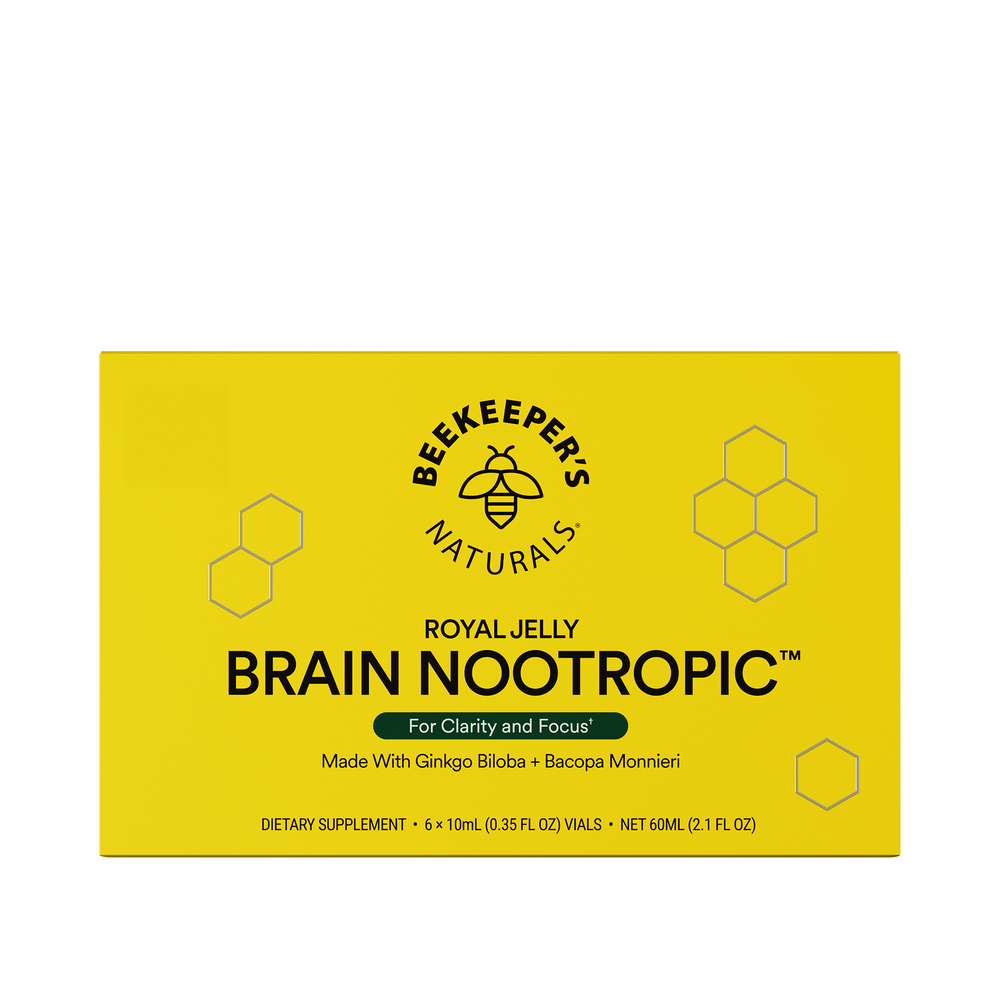 A yellow box of Beekeeper's Naturals Royal Jelly Brain Nootropic, with hexagonal patterns and branding information.