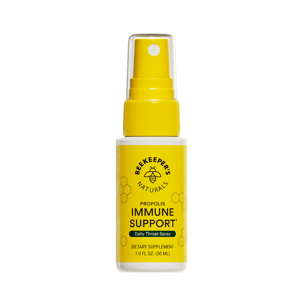 A yellow spray bottle labeled 'Beekeeper's Naturals Immune Support Propolis Throat Spray' with a black background.