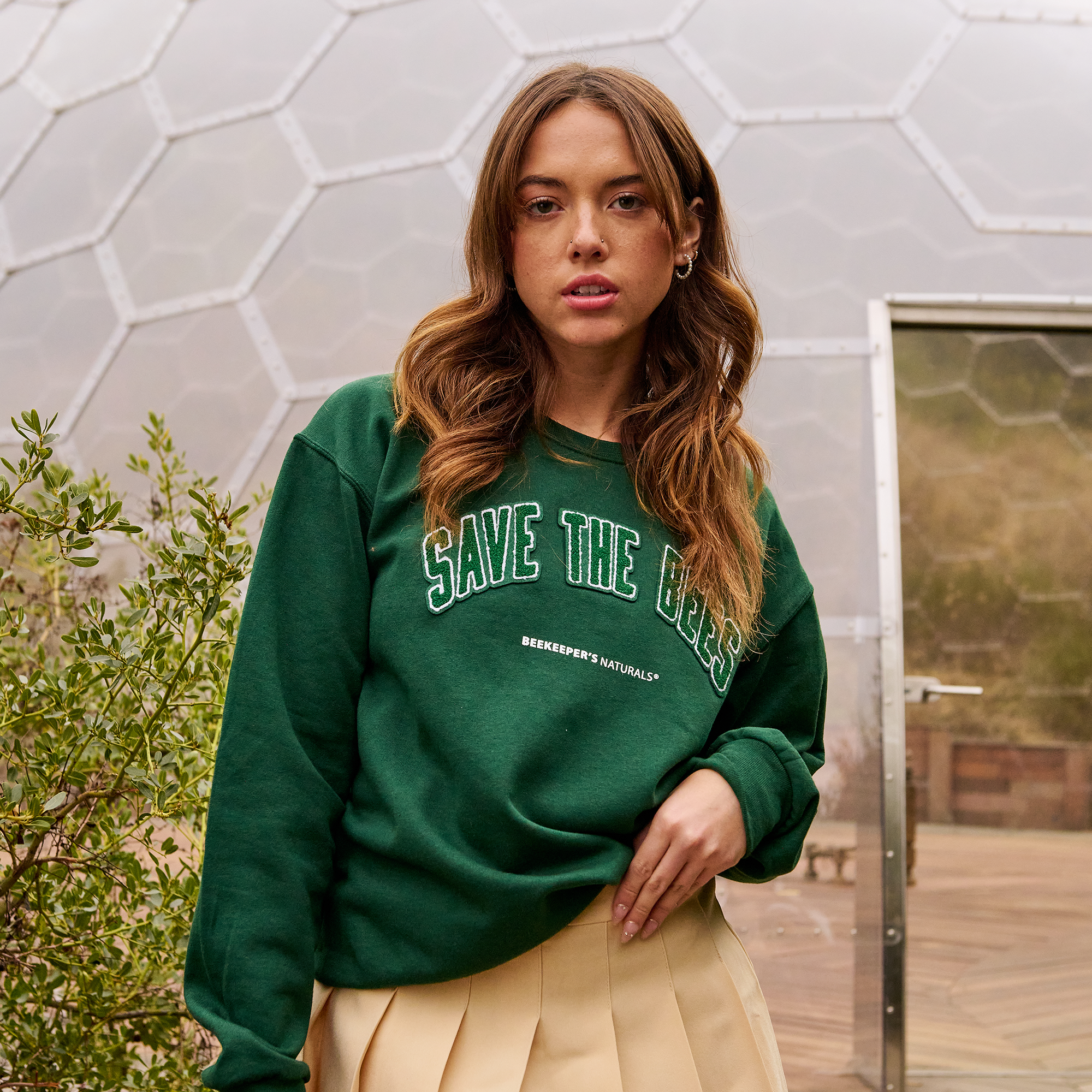 Model wearing the "Save The Bees Crew" sweatshirt, Junior Varsity Edition. Supports beekeeping and natural products.