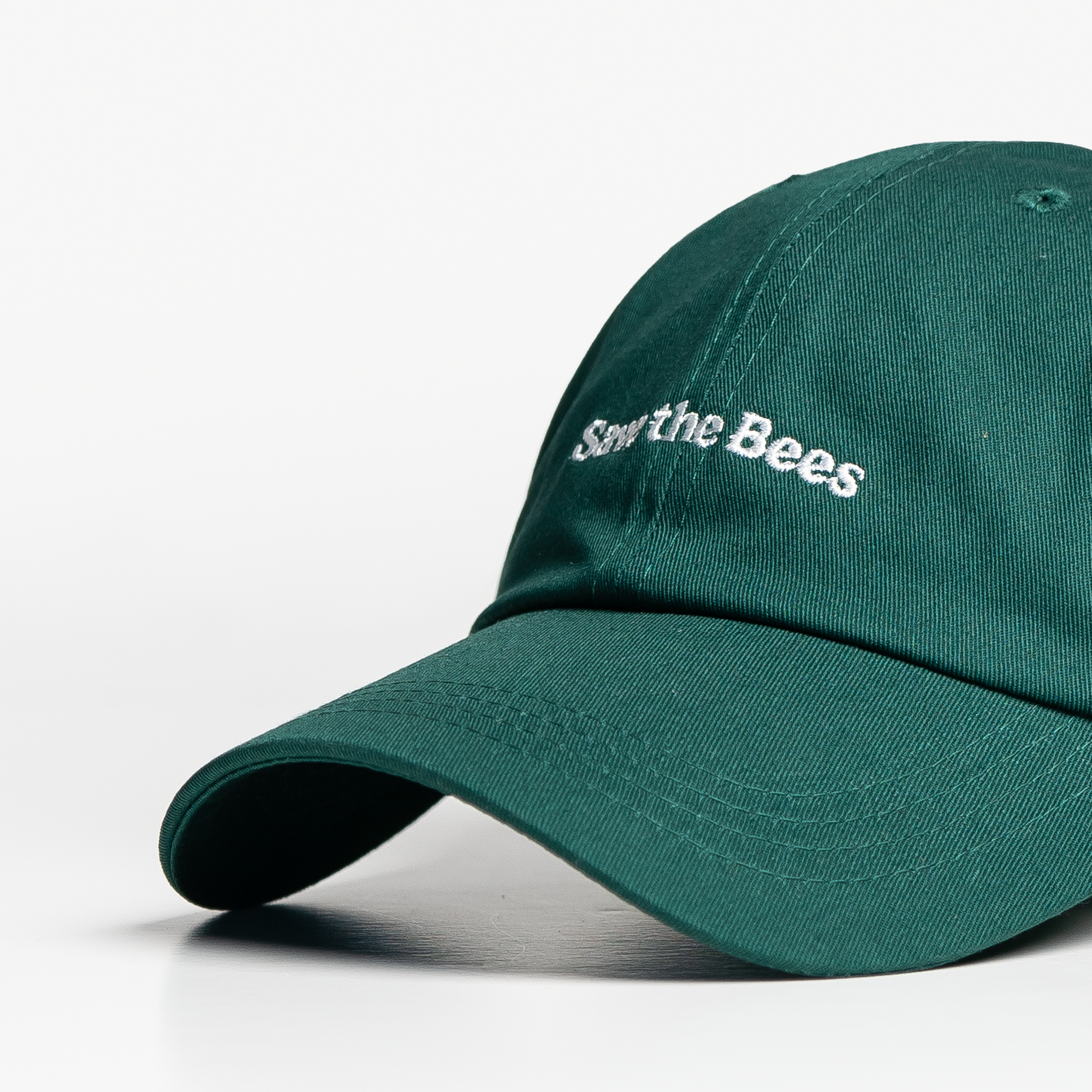 Green cap with 'Save the Bees' text on a white background