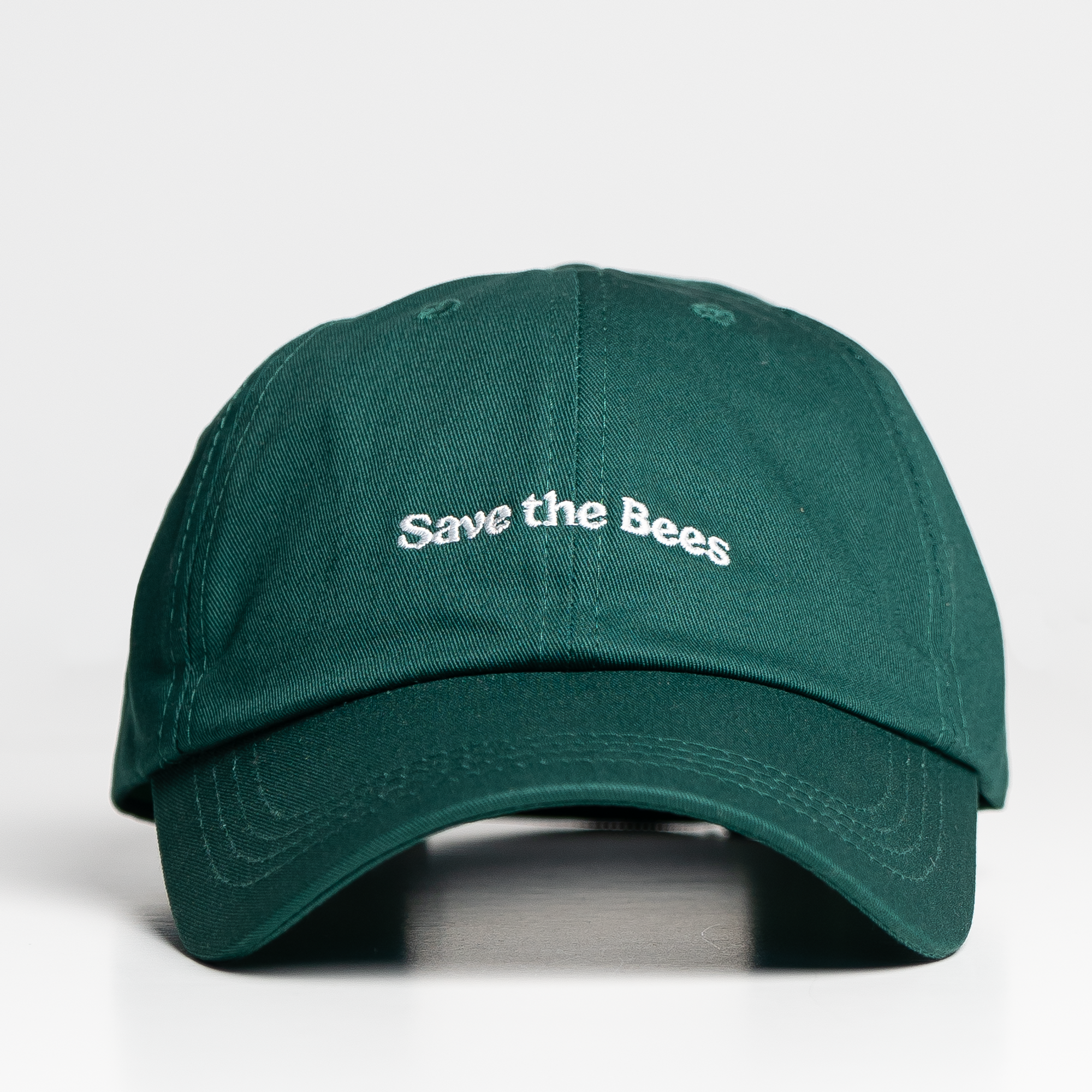 Green cap with 'Save the Bees' text on a white background