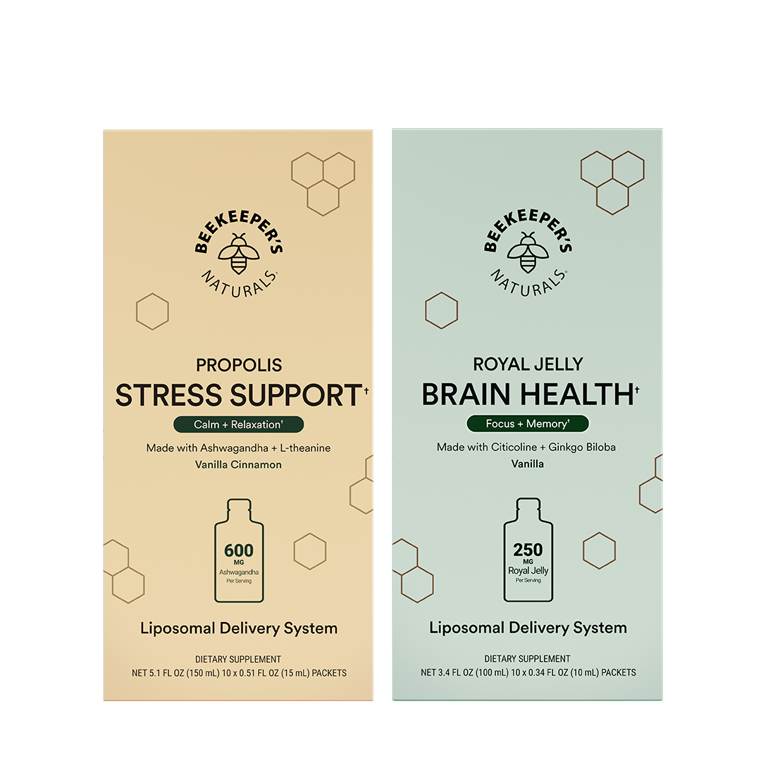 Two vertical supplement boxes from Beekeepers Naturals on a white background: Propolis Stress Support in beige and Royal Jelly Brain Health in pale green. Each box shows the brand logo, product name, ingredients, a bottle icon, and dosage information.