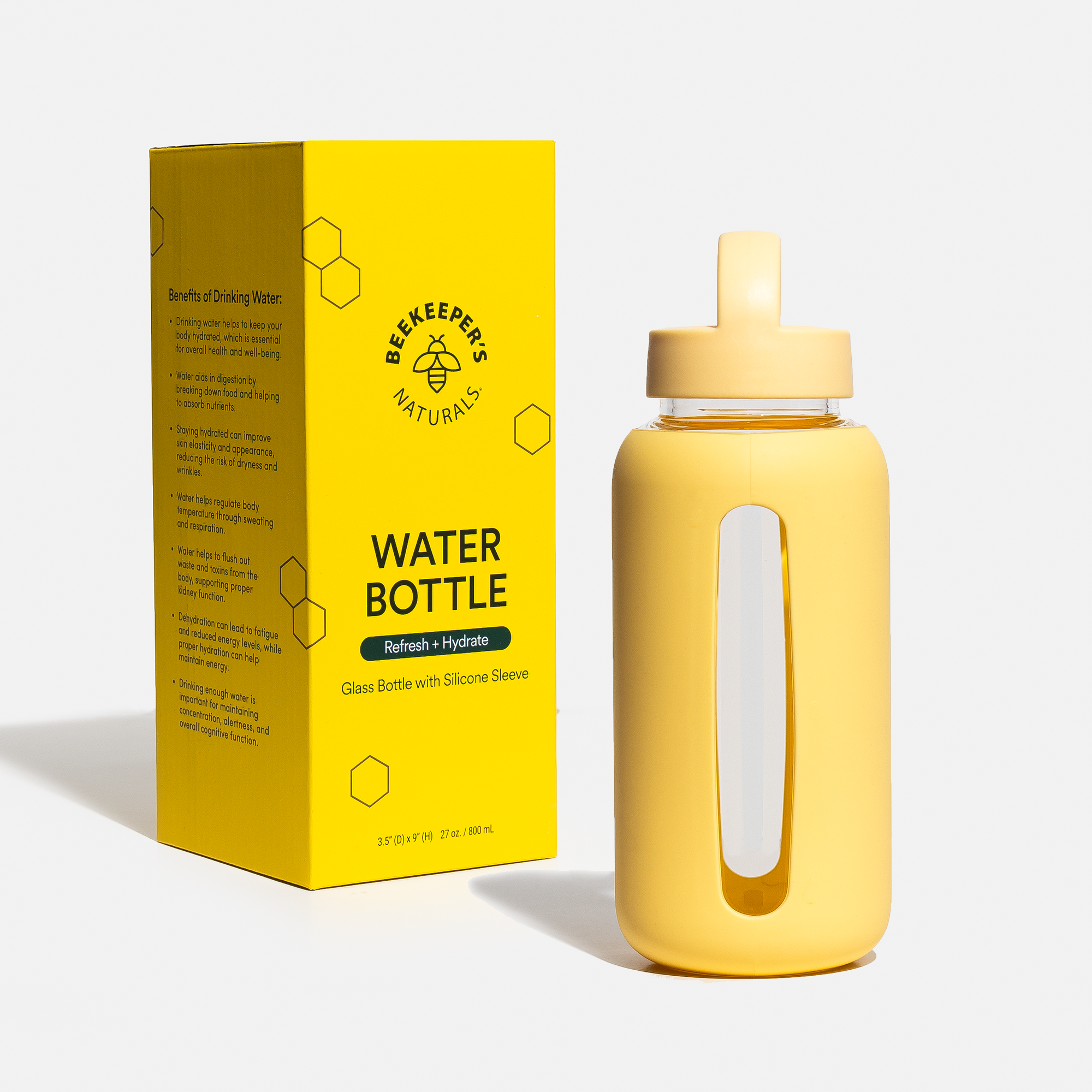 BKN reusable glass water bottle with protective silicone sleeve next to its packaging highlighting benefits of hydration.