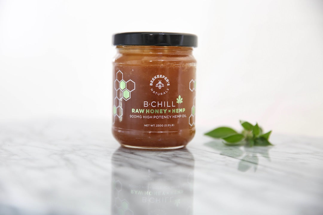 Front view of B.Chill raw honey + hemp jar showing label B‑CHILL RAW HONEY + HEMP 900mg on marble surface with mint sprig