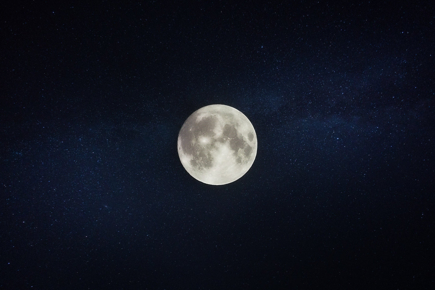 Full moon centered against a starry night sky evoking nighttime calm and sleep