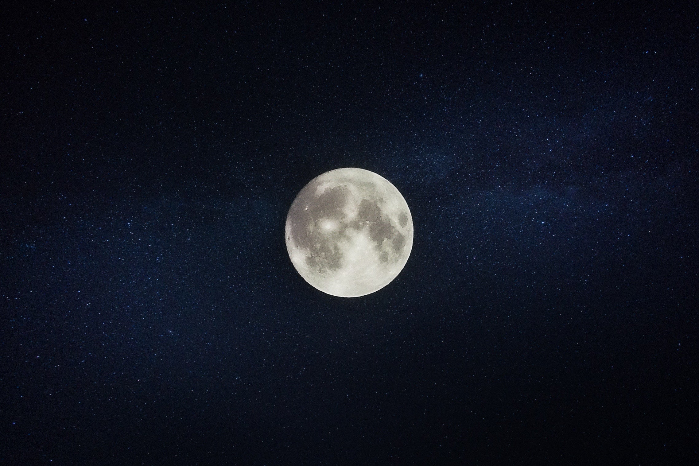 Full moon centered against a starry night sky evoking nighttime calm and sleep