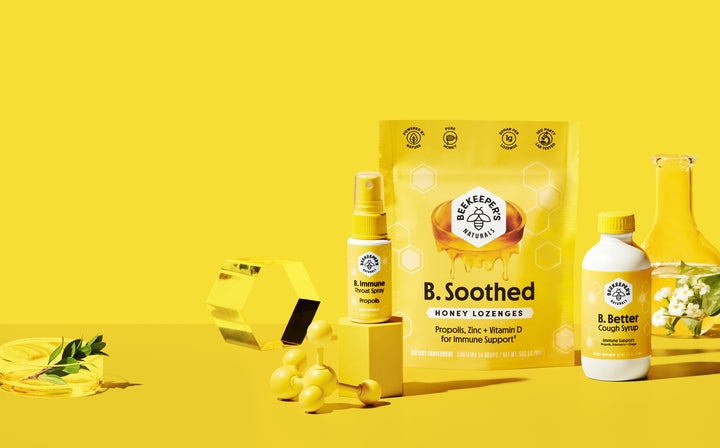 Front view of B. Soothed honey lozenges pouch with B. Immune throat spray and B. Better cough syrup arranged on yellow background