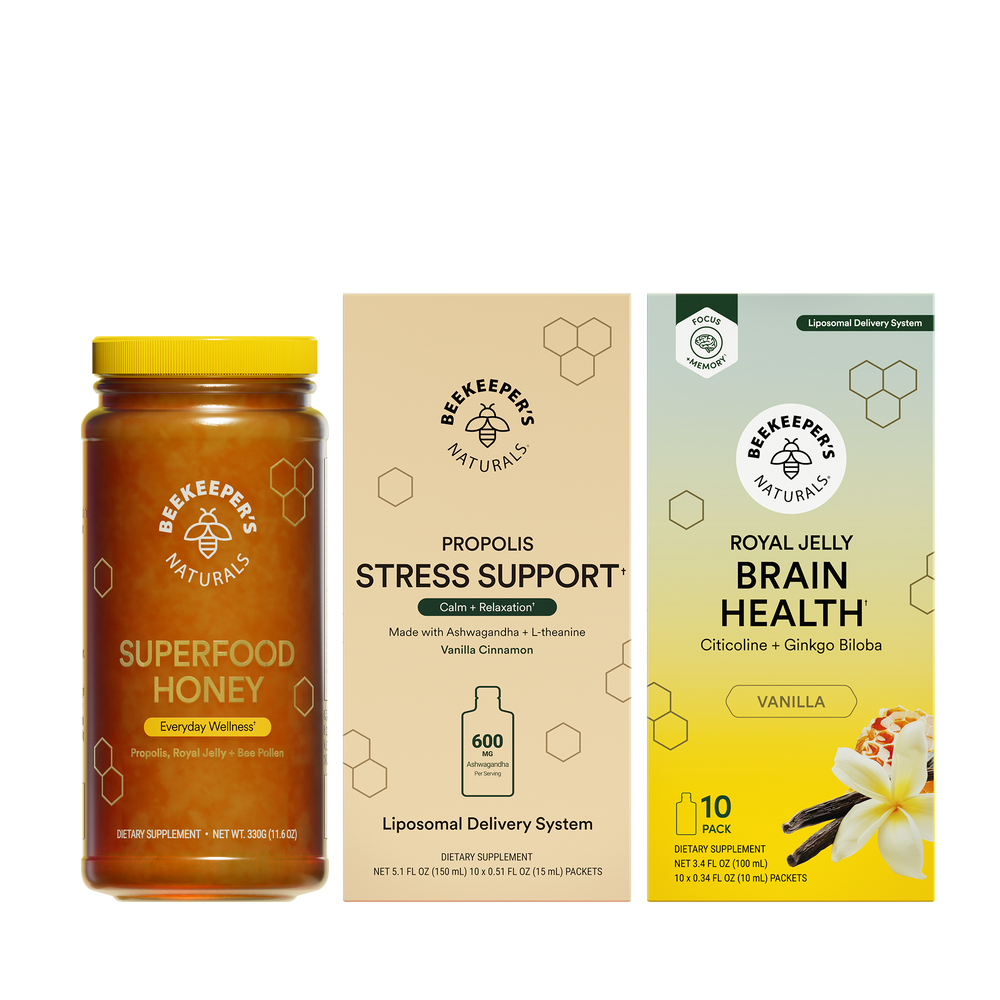 Superfood honey jar and two supplement packages on a white background