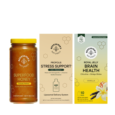 Superfood honey jar and two supplement packages on a white background