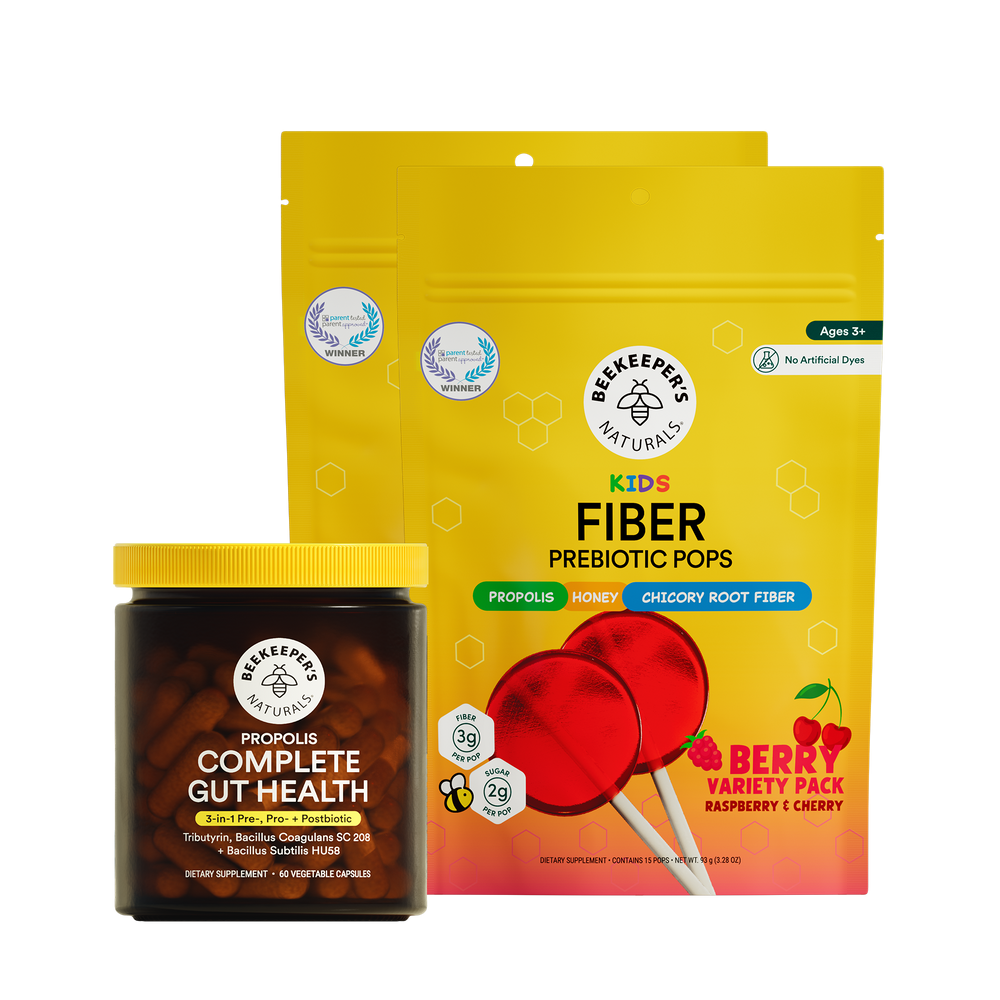 Two products from Beekeeper's Naturals: a jar labeled 'Complete Gut Health' and a package of 'Kids Fiber Prebiotic Pops' with red lollipops on a translucent background.
