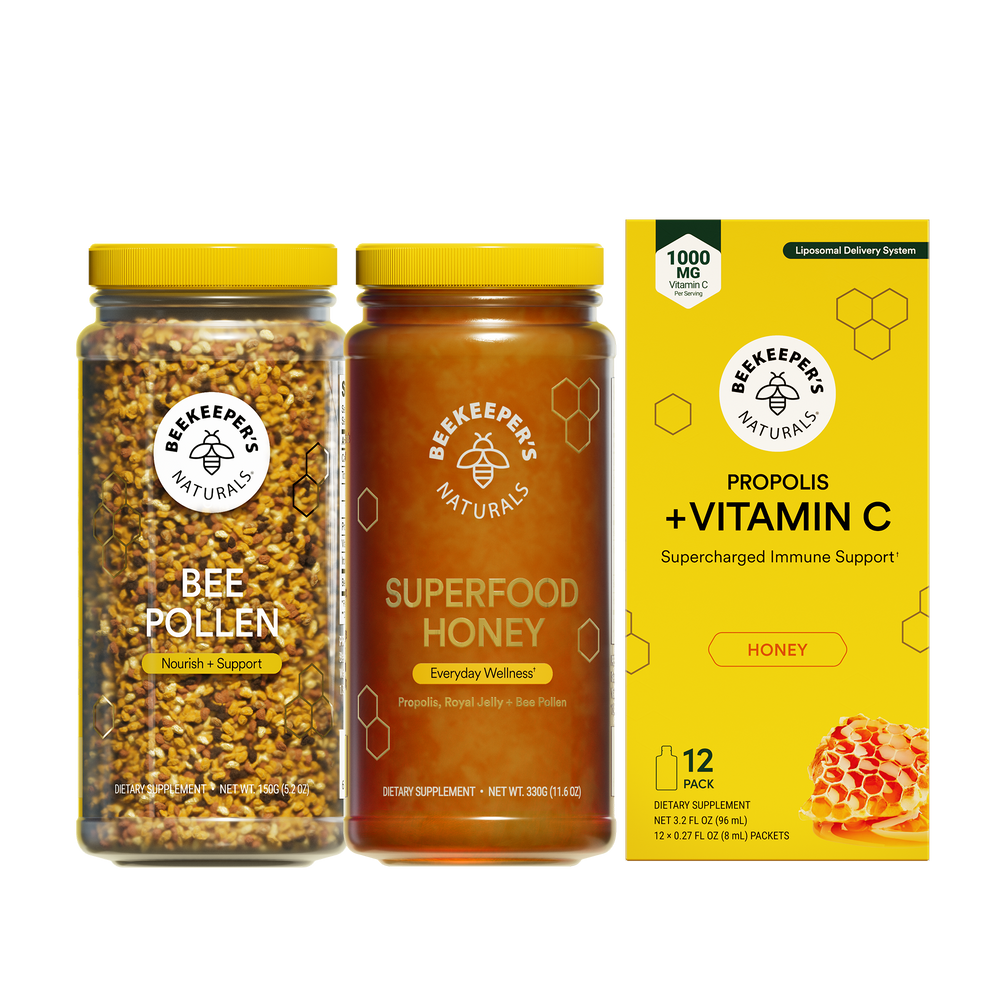 Three Beekeeper's Naturals products including bee pollen, superfood honey, and a vitamin C supplement box on a white background.