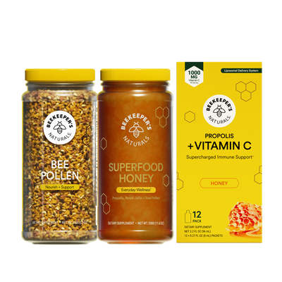 Three Beekeeper's Naturals products including bee pollen, superfood honey, and a vitamin C supplement box on a white background.