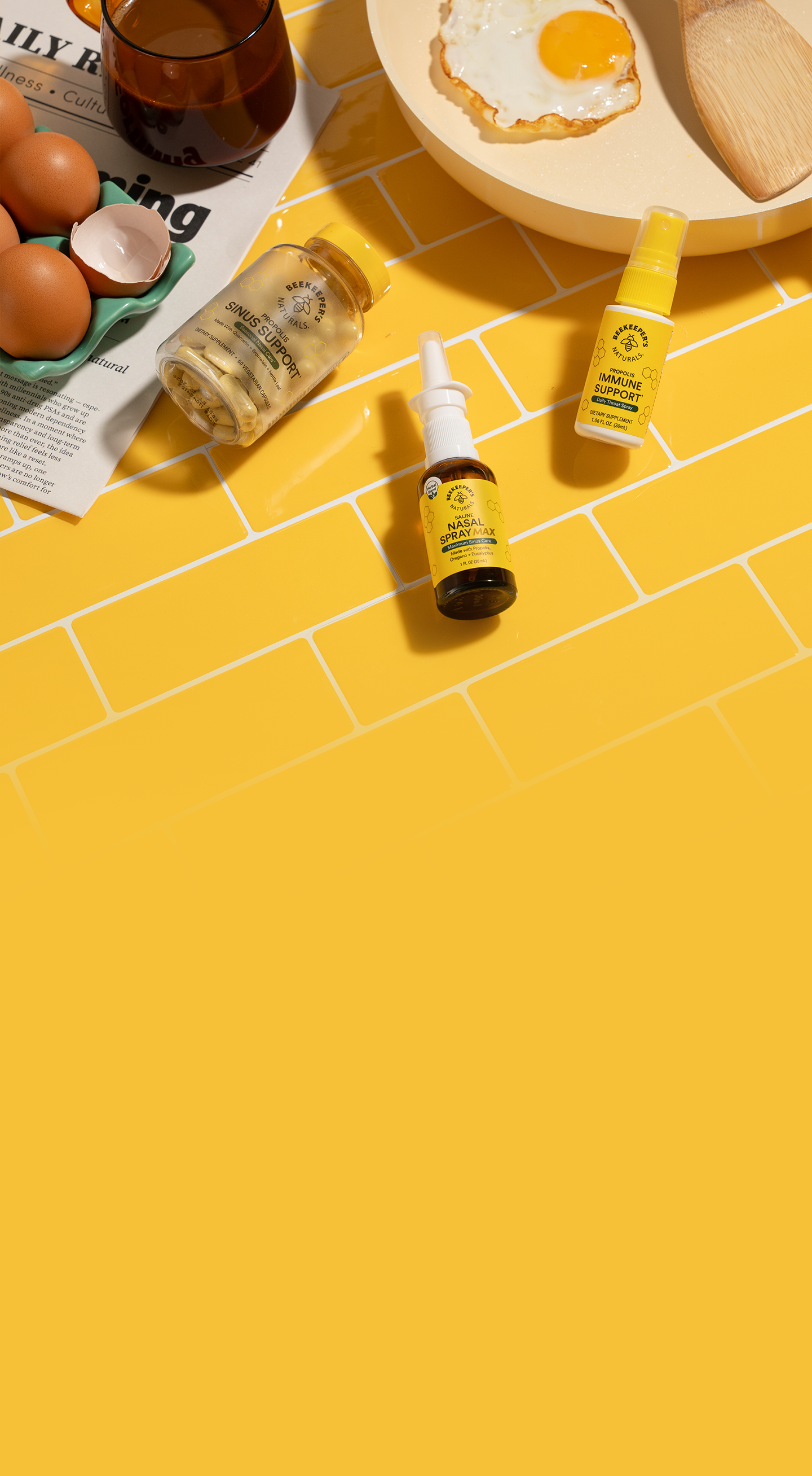 Bottles of skincare products on a yellow tiled floor with eggs and bread in the background.