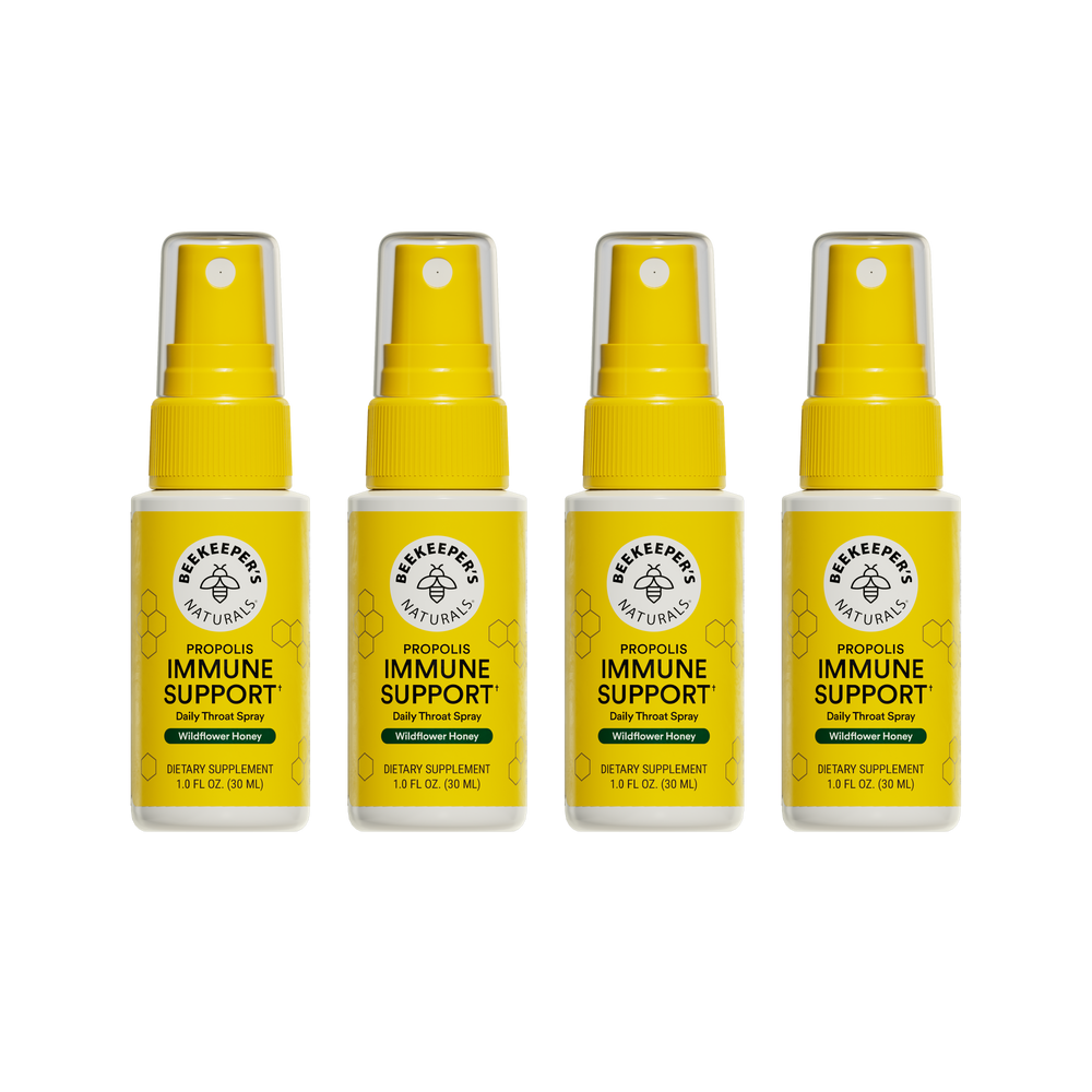 Four bottles of Beekeeper's Naturals Propolis Immune Support daily throat spray on a white background