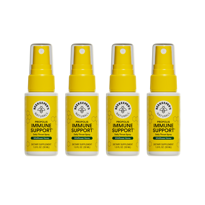 Four bottles of Beekeeper's Naturals Propolis Immune Support daily throat spray on a white background
