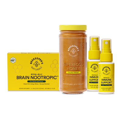 Beekeepers Naturals products including a jar of honey, a box of Brain Nootropic, and two bottles of Immune Support on a white background.
