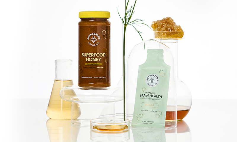 Brain health supplements arranged with honey and botanical ingredients in a bright laboratory-inspired setting