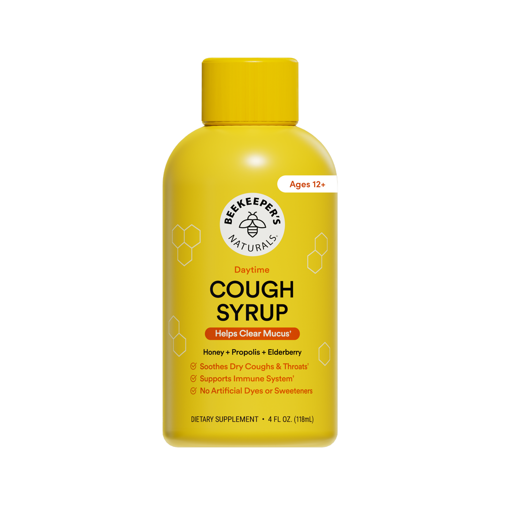 A yellow bottle of Beekeepers Naturals Cough Syrup with a yellow cap, shown on a plain white background. The label includes the brand logo, product name, and age rating.