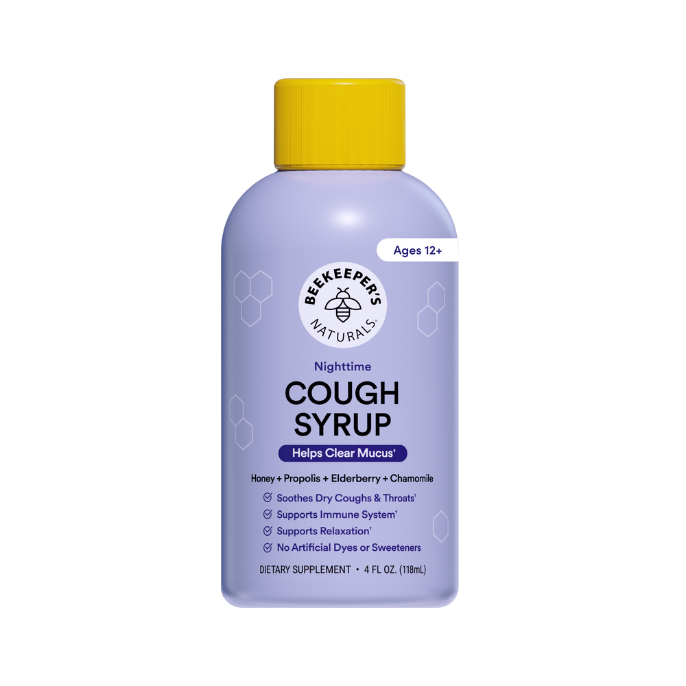 A bottle of Beekeepers Naturals Nighttime Cough Syrup with a light purple body, yellow cap, and white label, shown on a plain white background.