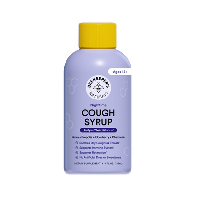 A bottle of Beekeepers Naturals Nighttime Cough Syrup with a light purple body, yellow cap, and white label, shown on a plain white background.
