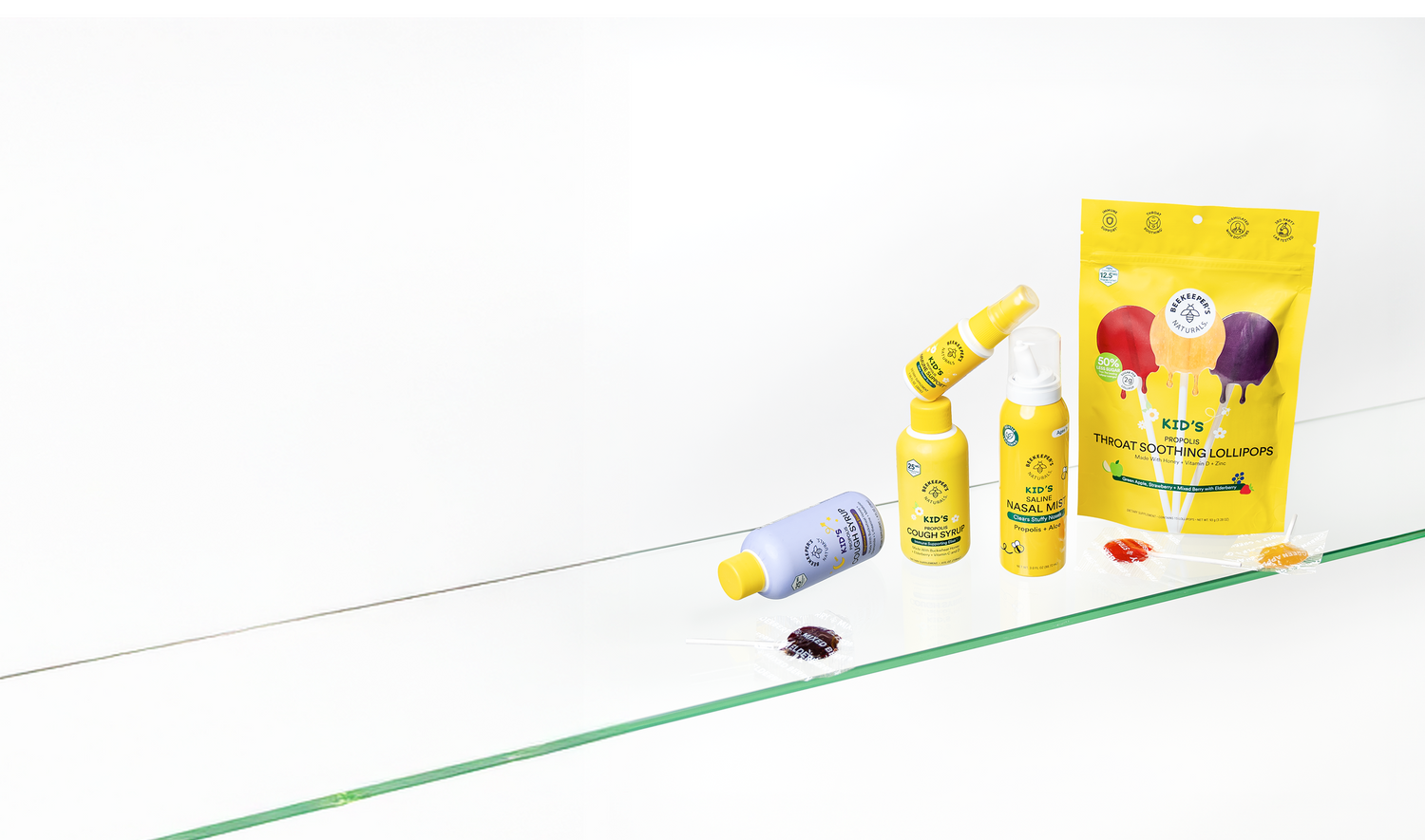 Beekeeper's Naturals products including a bottle, two sprayers, and a bag on a white background