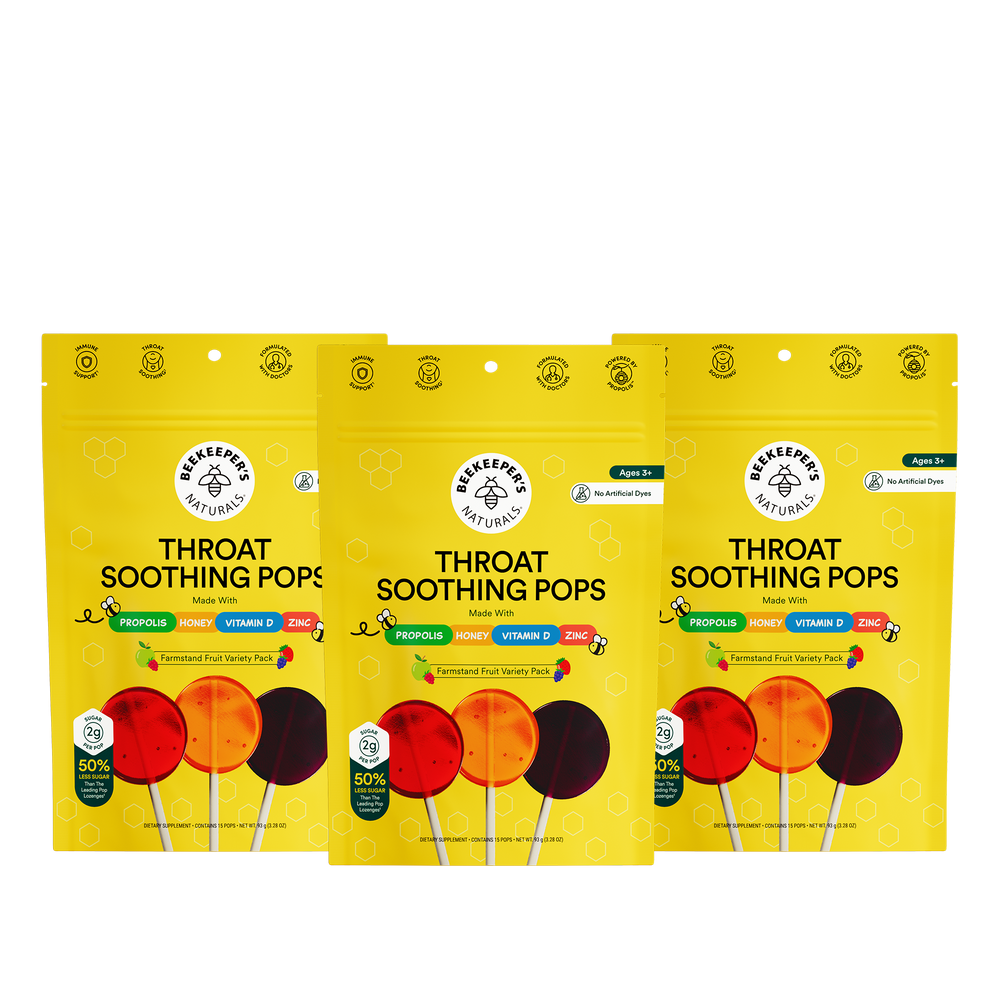 Three packages of Beekeepers Naturals Throat Soothing Pops on a white background