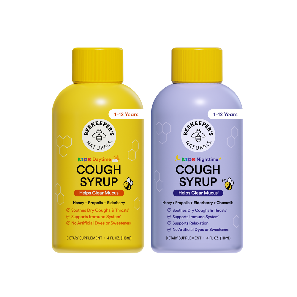 Two bottles of Beekeeper's Naturals cough syrup, one yellow and one purple, on a white background.