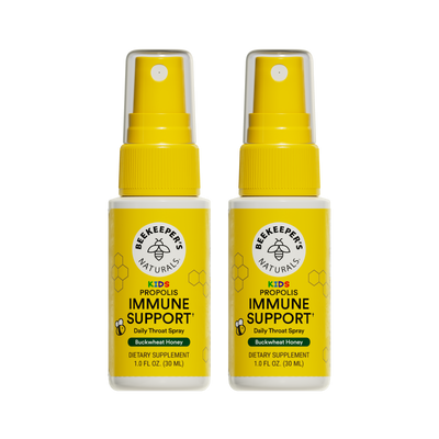Two bottles of Beekeeper's Naturals Kid's Propolis Immune Support daily throat spray on a white background