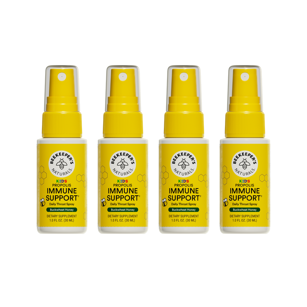 Four bottles of Beekeeper's Naturals Kid's Propolis Immune Support daily throat spray on a white background