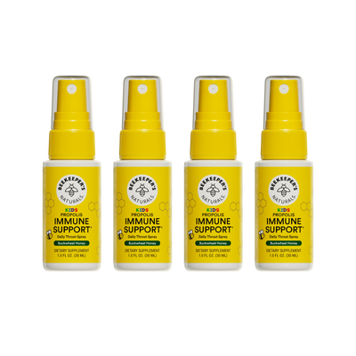 Four bottles of Beekeeper's Naturals Kid's Propolis Immune Support daily throat spray on a white background