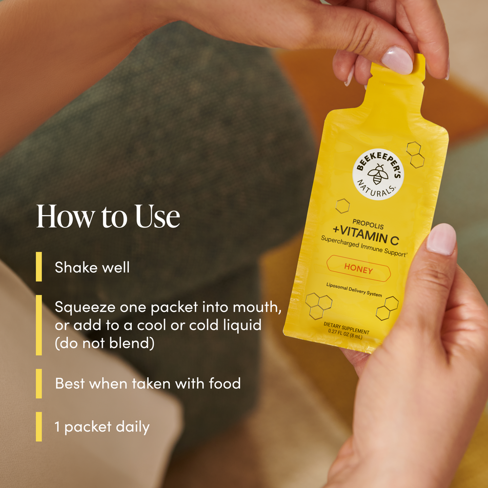 Yellow supplement packet with text on how to use it, held by a person.