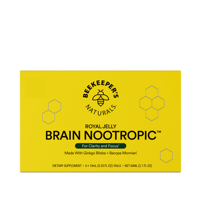 A yellow box of Beekeeper's Naturals Royal Jelly Brain Nootropic, with hexagonal patterns and branding information.