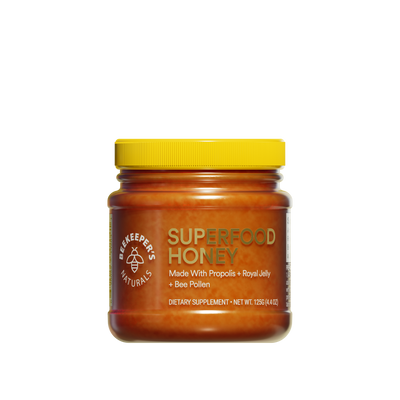A jar of Superfood Honey 125g with a yellow lid, label displays the product name and mentions Propolis, Royal Jelly, and Bee Pollen as ingredients.