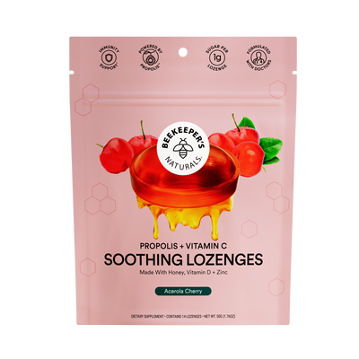 Packaging for Beekeeper's Naturals Propolis + Vitamin C Soothing Lozenges with an illustration of cherries and a honeycomb design element, against a pink background.