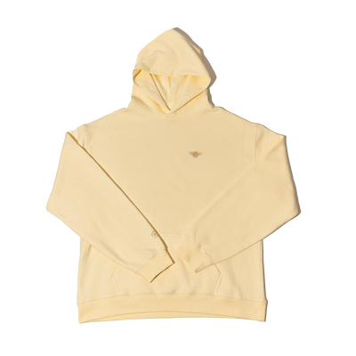 Front view of Save The Bees Hoodie Spring Edition cream pullover showcasing small bee chest logo and kangaroo pocket on white background