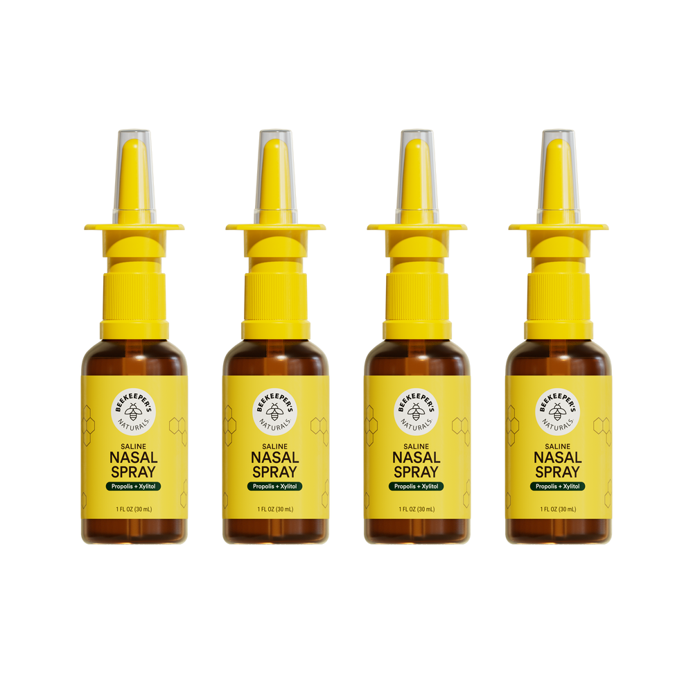 Front view of four Beekeeper's Naturals Saline Nasal Spray 1 fl oz bottles showing yellow labels and nasal applicators on white background