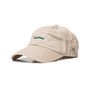 Three-quarter view of the Save the Bees Heritage Dad Hat showcasing forest-green embroidery and side logo on a transparent background