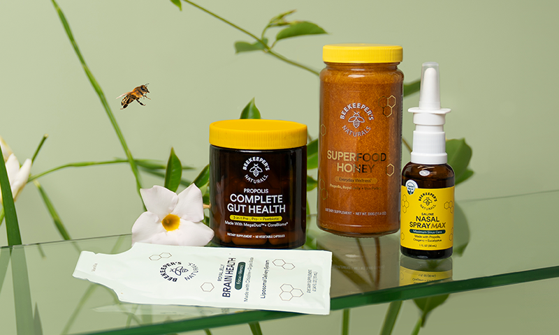 Collection of health and wellness products on a glass surface with a natural background