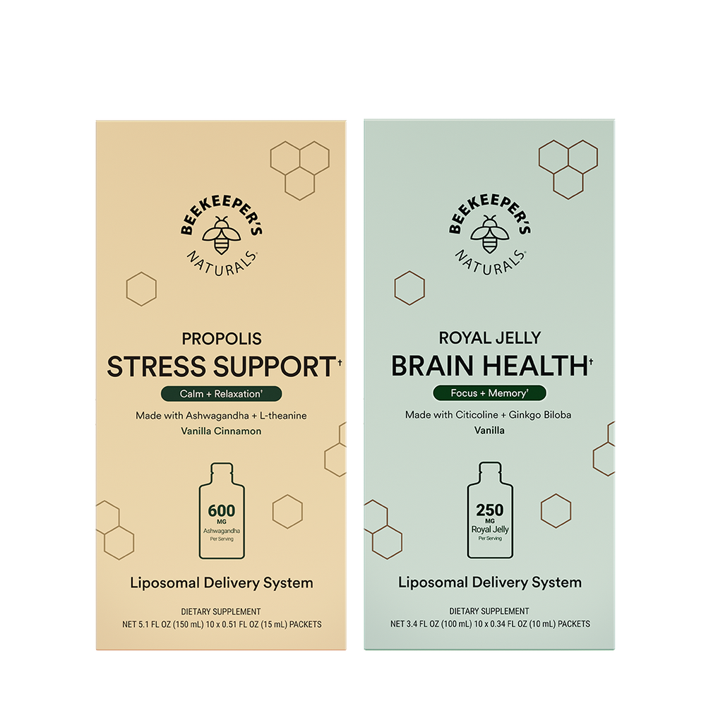 Two vertical supplement boxes from Beekeepers Naturals on a white background: Propolis Stress Support in beige and Royal Jelly Brain Health in pale green. Each box shows the brand logo, product name, ingredients, a bottle icon, and dosage information.