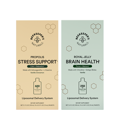 Two vertical supplement boxes from Beekeepers Naturals on a white background: Propolis Stress Support in beige and Royal Jelly Brain Health in pale green. Each box shows the brand logo, product name, ingredients, a bottle icon, and dosage information.