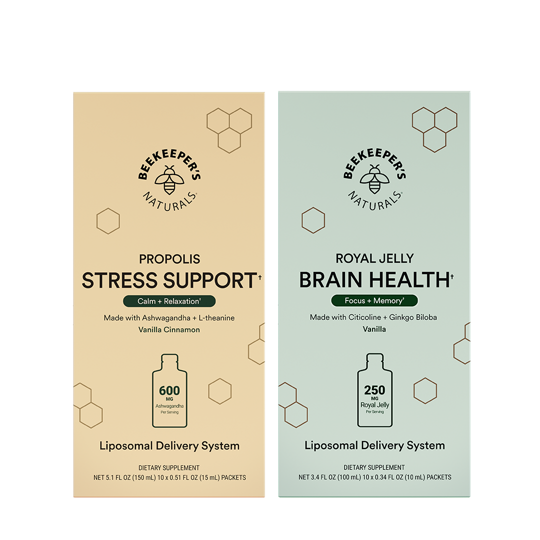 Two vertical supplement boxes from Beekeepers Naturals on a white background: Propolis Stress Support in beige and Royal Jelly Brain Health in pale green. Each box shows the brand logo, product name, ingredients, a bottle icon, and dosage information.