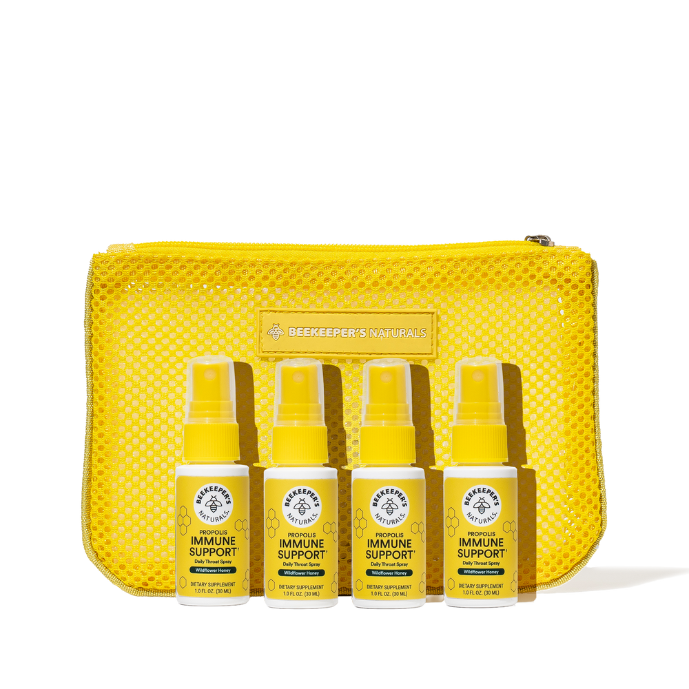 Set of yellow immune support products with a mesh pouch on a white background