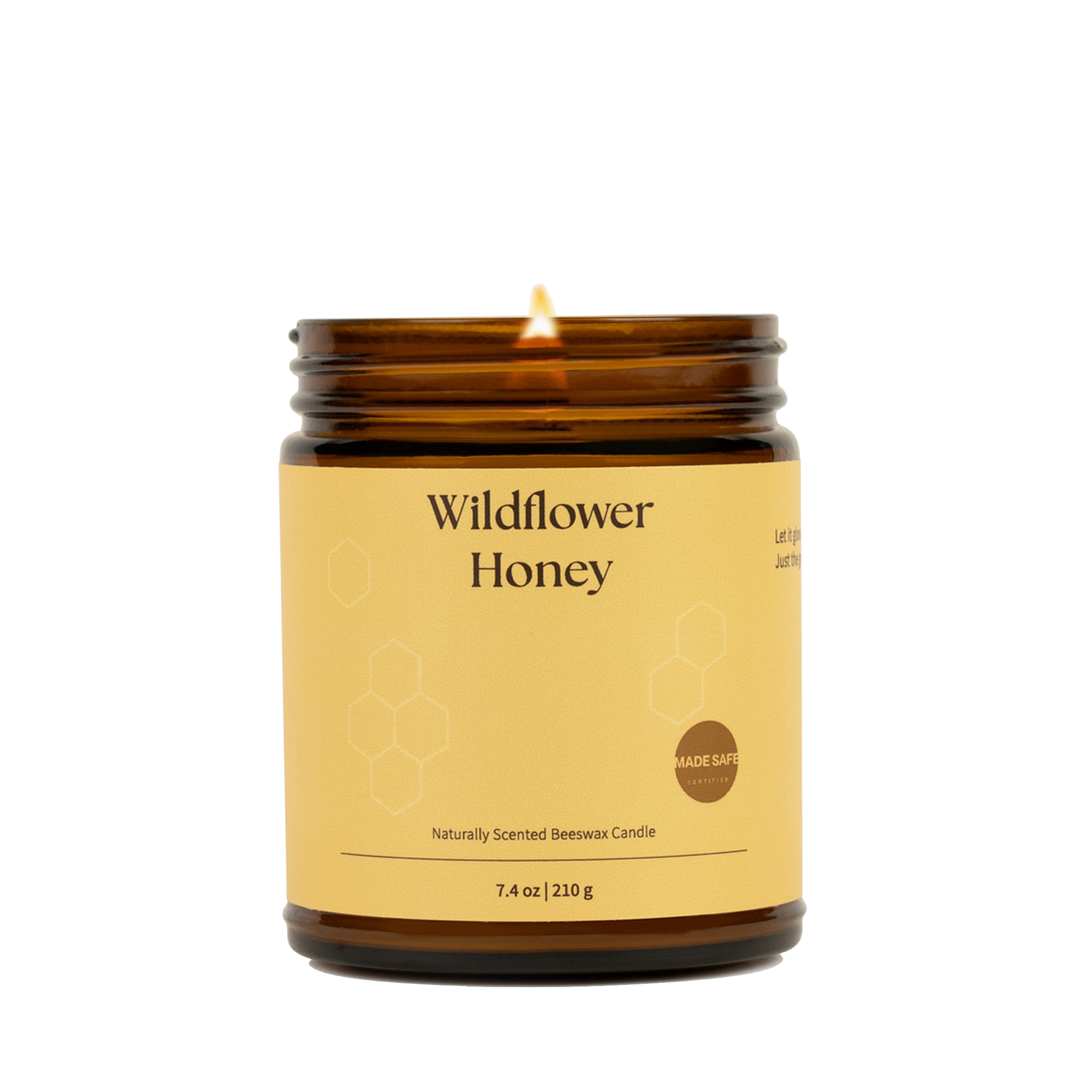 Candle in an amber jar labeled 'Wildflower Honey' on a white background