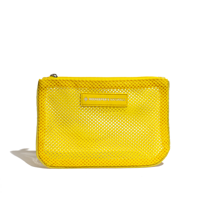 Yellow mesh pouch from Beekeepers Naturals. Great for travel, organizing small items, or carrying essentials.
